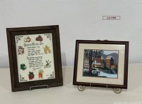 Both framed needlepoint pieces displayed side by side