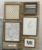 All five framed pieces displayed on wall