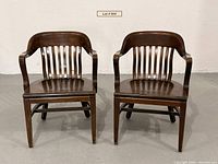 Both Gunlocke walnut banker’s chairs front view