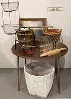 Full lot overview showing pie plates, baskets, frames, stand, peeler, rolling pin, white basket
