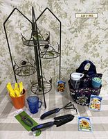Entire lot showing plant stand, tools, tote, pitcher, pot, gloves, seed packets