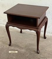 Full view of mahogany side table showing cabriole legs and open shelf