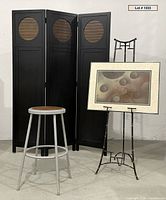 Full view of divider, stool, easel holding artwork