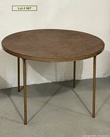 Full view of Cosco round folding card table standing upright