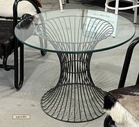 Full view of table showing glass top and wire pedestal base