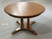 Full view of round wooden pedestal table