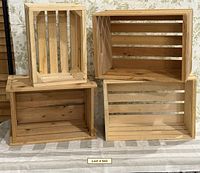 Four wooden storage crates displayed together
