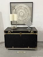 Front view of trunk with lamp, art, jar displayed