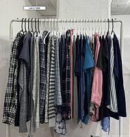 Full rack of assorted women’s tops showing quantity and variety