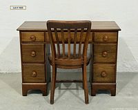 Front view of desk and chair showing all six drawers and slat-back design
