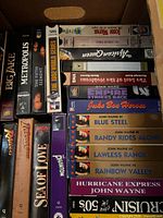Box of vertically and horizontally stacked VHS tapes showing movie titles Big Jake through Phantom