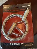 Front of packaged 5 ft drain snake