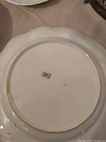 Underside of scalloped edge plate showing green England backstamp