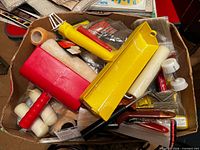 Box containing assorted paint rollers, trays, brushes and accessories