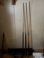 Pool cues and partial view of cue repair kit