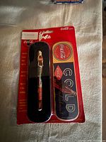 Packaged Coca-Cola collector pen and tin case set