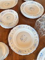 Stacked dinner, salad and soup plates with tumblers