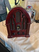 Front view of GE wooden cathedral radio showing grille, dial and knobs