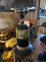 Coleman propane cylinder with attached single-burner stove