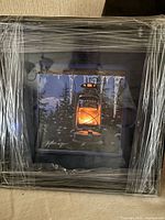 Front view showing framed print with protective wrap