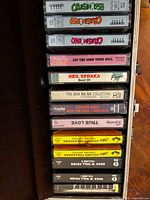 Open carrying case showing stacked labeled cassette spines