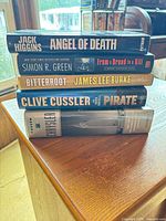Stack of five hardcover books showing all spines