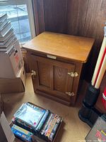 Full view of nightstand showing door, brass hardware, overall design