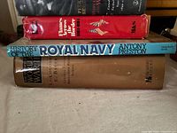 Stack of five books showing spines and dust jackets