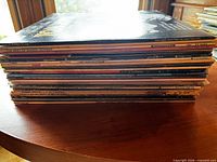 Side view of stacked vinyl LP records showing quantity