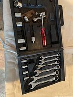 Open blow-mold case showing sockets, ratchet handle, screwdrivers and wrenches
