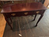 Front view of sofa table showing drawers and legs