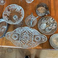 Group shot showing all cut glass pieces, silverplate cruet set and sugar bowl