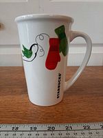 Front view showing dove, mittens graphic and Starbucks wordmark