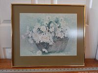 Full view of framed floral print with ruler for scale