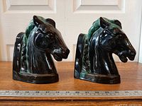 Front view of both horse head bookends side by side