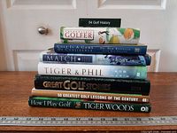 Stacked view of eight golf books showing titles on spines