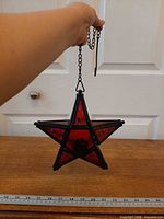 Full view of hanging star lantern with chain showing scale