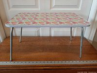 Tray top showing fruit pattern and folded legs extended