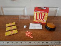 Full contents laid out: prompt cards, tokens, die, buzzer, tray, box, instructions