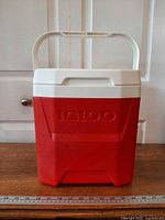 Front view red Igloo Laguna cooler raised base