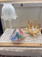 Overall view of three glass items with ruler for scale
