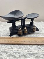 full view of scale with brass weights and ruler for size