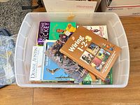 Plastic tote with assorted books including Writing 1-2-3 and others
