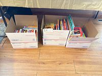 Three USPS boxes filled with assorted children’s and YA books