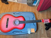Full view of guitar showing size, color gradient, body and neck