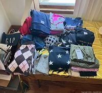 Overall view of folded assorted clothing on table