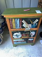 Front view of cabinet showing painted drawer fronts and overall design