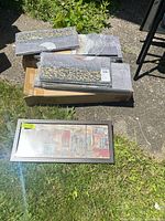 Stack of wrapped framed panels and one unwrapped long panel visible