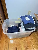 Tote containing folded jeans, sweatpants and joggers