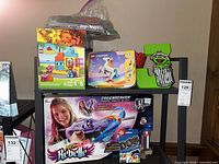 Overall lot view showing all boxed items on shelf